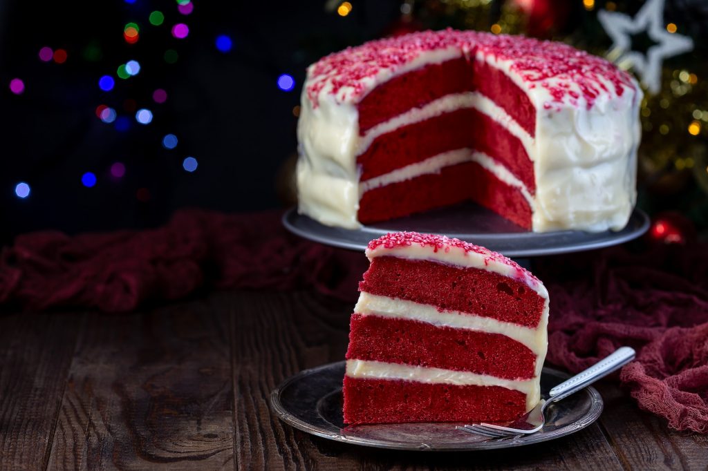 Piece of red velvet cake with cream cheese frosting
