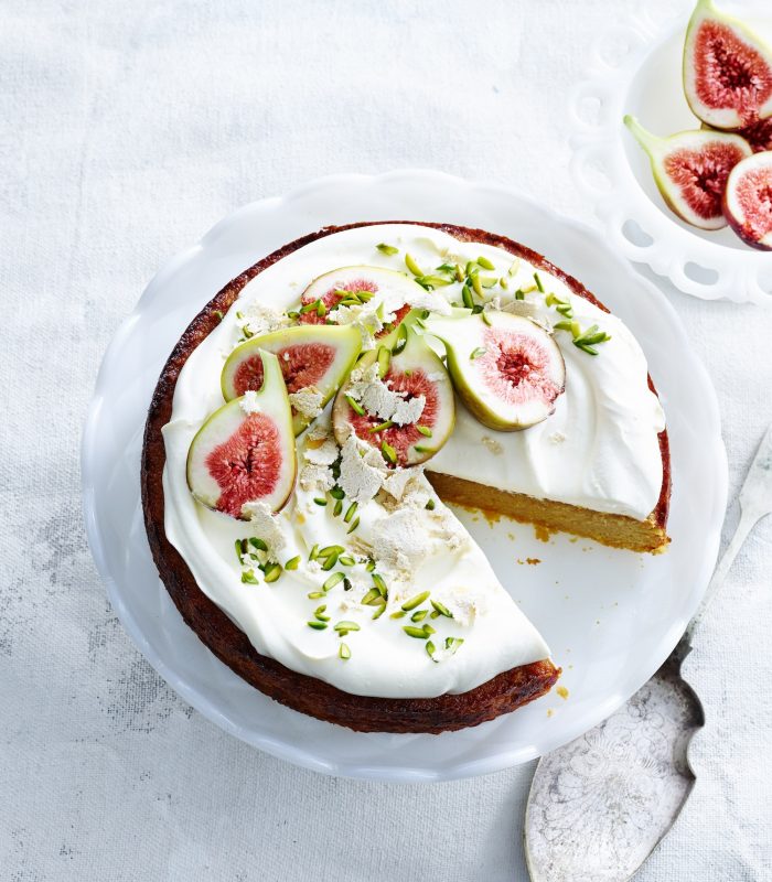 overhead-view-of-orange-and-almond-cake-with-yoghurt-cream-pistachios-figs-and-cake-server.jpg